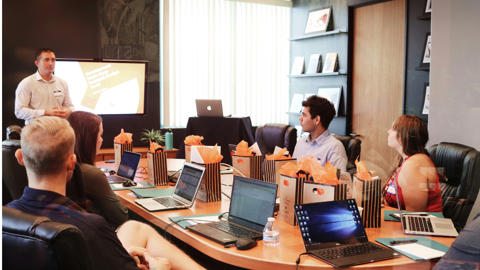 People seated a desk having a meeting